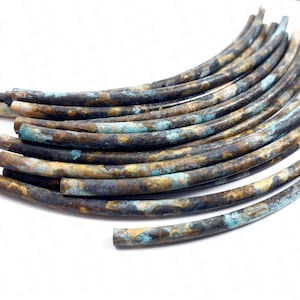 May include: A close-up of a pile of copper wire beads. The beads are a mix of brown, gold, and blue colours. The beads are all about 1.2 cm in diameter.
