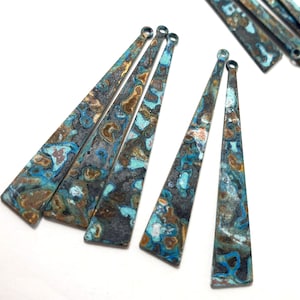 May include: Five long, narrow, triangular metal pendants with a mottled blue, green, and brown finish. The pendants have a hole at the top for hanging.