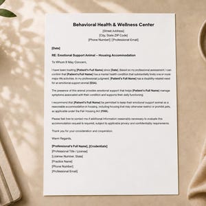 May include: A white document titled Behavioral Health & Wellness Center, RE: Emotional Support Animal – Housing Accommodation, with placeholders for patient and professional details, printed on standard A4-sized paper.