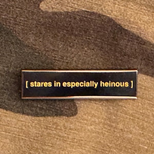 Stares in Especially Heinous Closed Caption Enamel Pin