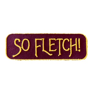 May include: A maroon fabric patch with yellow embroidered text that reads "SO FLETCH!"