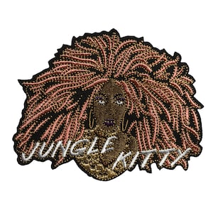 May include: Embroidered patch featuring a stylized portrait of a woman with brown skin, purple lips, and large gold hoop earrings. The woman has long, pink and brown hair. The words "JUNGLE KITTY" are embroidered in white.