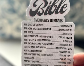 May include: A white sticker with the word "Bible" in black cursive lettering. The sticker lists Bible verses for different situations, such as grief, hope, peace, confidence, forgiveness, endurance, patience, decision making, gratitude, healing, trusting God, overcoming temptation, and love and compassion.