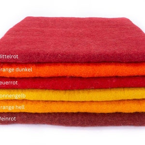 Op de afbeelding: Een stapel van zes viltvierkanten in verschillende tinten rood, oranje en geel. De vierkanten zijn van boven naar beneden gelabeld: Mittelrot, Orange dunkel, Feuerrot, Sonnengelb, Orange hell en Weinrot.