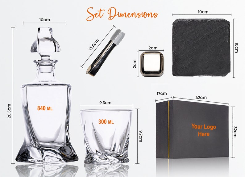 May include: A black gift box with gold trim, a clear glass decanter with a stopper, a clear glass tumbler, a pair of silver tongs, and a black slate coaster. The box has the text "Your Logo Here" printed on it. The decanter holds 840 ml and the tumbler holds 300 ml.