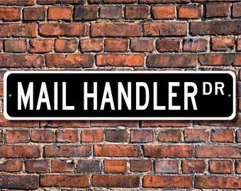 May include: Black and white street sign with the text "MAIL HANDLER DR."
