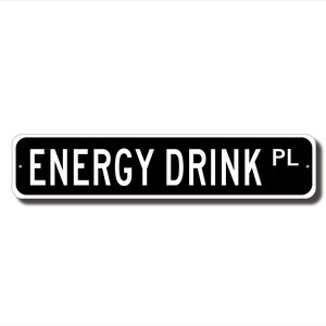 A black and white rectangular sign with the text "ENERGY DRINK PL" printed on it.
