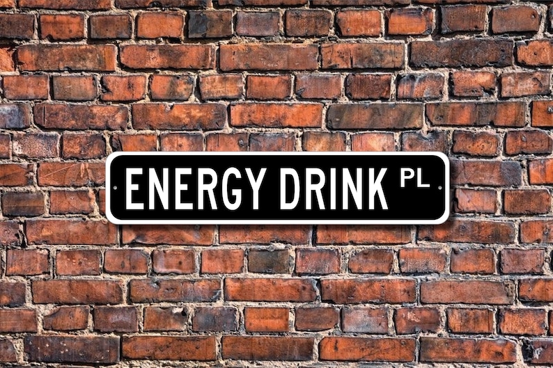 a sign that says "Energy Drink PL" against a brick wall background.