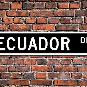 May include: Black and white street sign with the text "ECUADOR DR." in white letters on a black background.