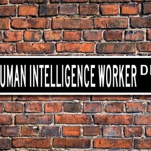 May include: Black and white street sign with the text "HUMAN INTELLIGENCE WORKER DR."
