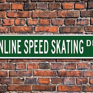 May include: Green street sign with white lettering that reads "INLINE SPEED SKATING DR."
