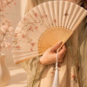 Elegant bamboo folding fan with a delicate floral design, perfect for weddings, bridal parties, summer events and thoughtful gifts