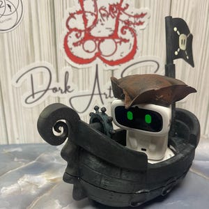 May include: A white AI robot with green eyes wearing a brown pirate hat, in a black pirate ship. The ship has a black flag with a skull and crossbones. The background has stickers and a wooden texture.