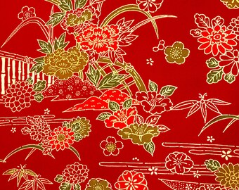 May include: Red fabric with a gold and red floral pattern. The pattern includes flowers, leaves, and a bamboo fence.