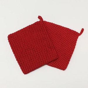 May include: Two red knitted pot holders with hanging loops.
