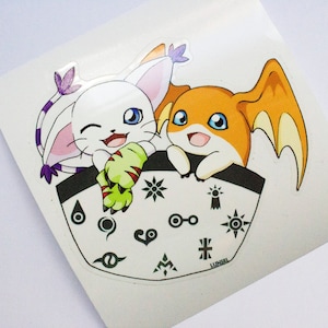 May include: A white and purple digimon character with green claws and a yellow digimon character with orange wings are in a pocket with black and white digimon symbols.