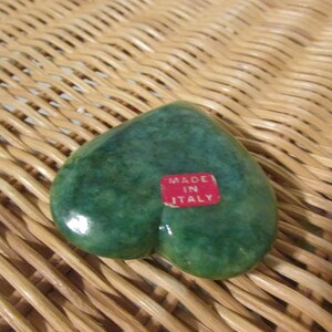 May include: Green heart-shaped trinket box made in Italy. The box is made of a smooth, polished stone.