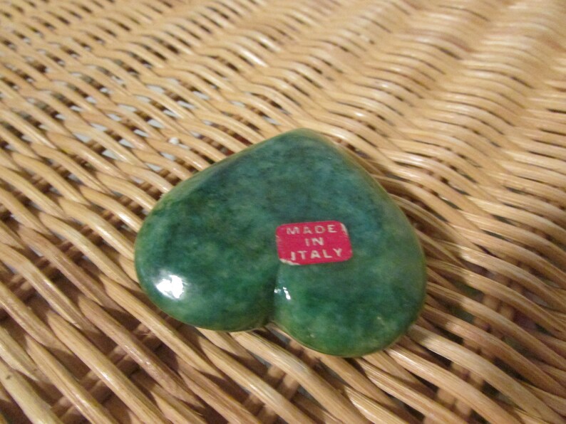 May include: Green heart-shaped trinket box made in Italy. The box is made of a smooth, polished stone.