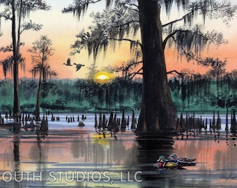May include: A watercolor painting of a sunset over a swamp. The sun is setting behind a large cypress tree with Spanish moss hanging from its branches. There are two ducks flying in the sky and a wood duck swimming in the water. The painting is signed "Gary Routh" in the lower right corner.