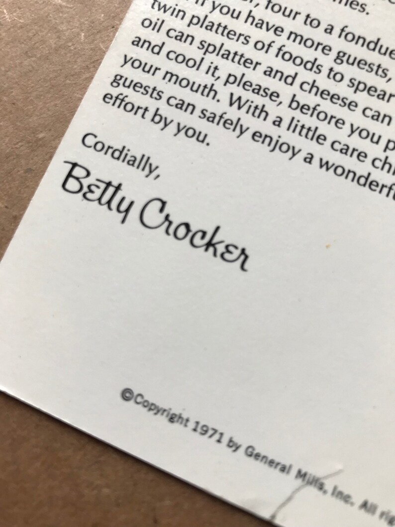 May include: A close-up of a white card with black text. The text reads "Cordially, Betty Crocker" and "Copyright 1971 by General Mills, Inc. All rights reserved."