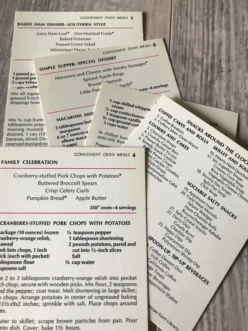 May include: A collection of recipe cards for convenient oven meals. The cards are printed with a white background and black text. The cards feature a variety of meal ideas, including baked ham dinner, simple supper, family celebration, and coffee cakes and rolls.