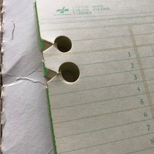 May include: A white ledger with green lines and a green National logo. The ledger has a white Eye-Ease label and the numbers 17-710 and 18-710.