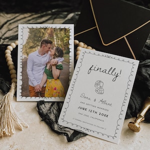 May include: Wedding invitation suite featuring a photo card and a text card with the words "finally!" and the names "Dana & Albert". The photo card has a picture of a couple. A black envelope and a gold wax seal are also present.