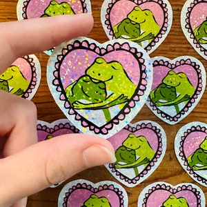 Hugging Frogs Sticker - holographic 2&quot; vinyl laptop sticker cute frog and toad in love in scalloped pink heart