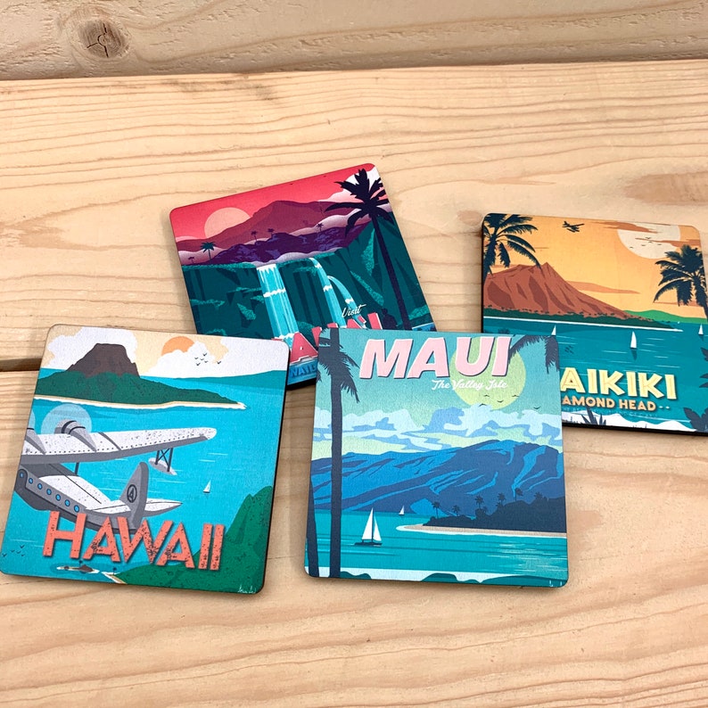May include: Four square coasters featuring colorful travel-themed illustrations of Hawaii. One shows a seaplane over water with the text HAWAII, another a waterfall, one depicts Maui with the text MAUI The Valley Isle, and one shows Waikiki with the text WAIKIKI DIAMOND HEAD.