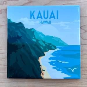 May include: A blue and green illustration of a coastline with a beach and ocean. The text "KAUAI HAWAII" is at the top of the image.