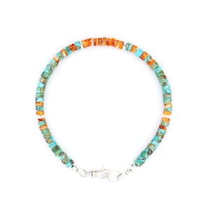May include: A circular bracelet composed of small, flat, disc-shaped beads in alternating shades of turquoise blue, green, and orange. The strand is accented with small, polished silver-toned metal spacers and features a silver-toned lobster claw clasp.