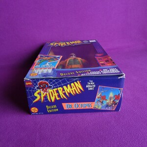 May include: A blue and red box with a Spider-Man figure of Dr. Octopus. The box features the text "Spider-Man Deluxe Edition Dr. Octopus" and "From The New Animated Series!" The figure is 10 inches tall and fully poseable.