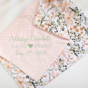 May include: A pink and white baby blanket with a floral pattern. The blanket is personalised with the name Addalyn Elizabeth, birth weight of 6 lbs 6 oz, birth length of 19.5 inches, and birth date of 21st July 2024.