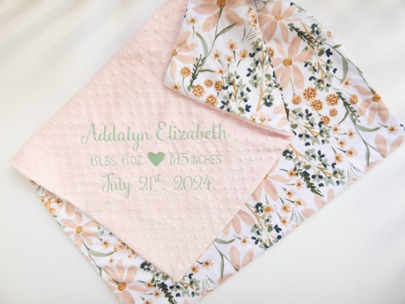 May include: A pink and white baby blanket with a floral pattern. The blanket is personalised with the name Addalyn Elizabeth, birth weight of 6 lbs 6 oz, birth length of 19.5 inches, and birth date of 21st July 2024.