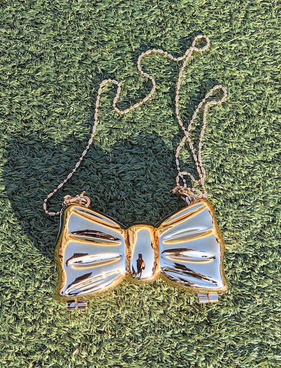 NWT Carissimo gold asymmetrical cloch with bow Rayne Gold Bow Clutch | Clutches | Handbags main image 4