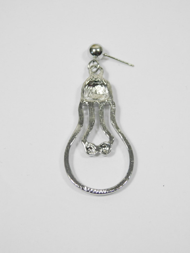 May include: Silver lightbulb shaped dangle earring with a clear rhinestone accent.