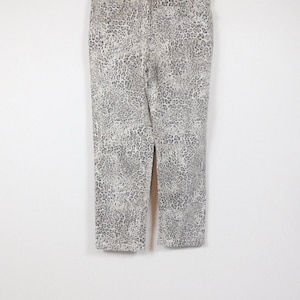 May include: A pair of light brown skinny jeans with a leopard print pattern.