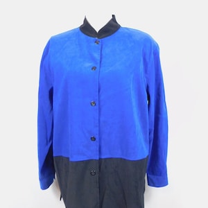 May include: A long-sleeved button-up shirt with a black collar and a color block design. The top half of the shirt is blue and the bottom half is black.