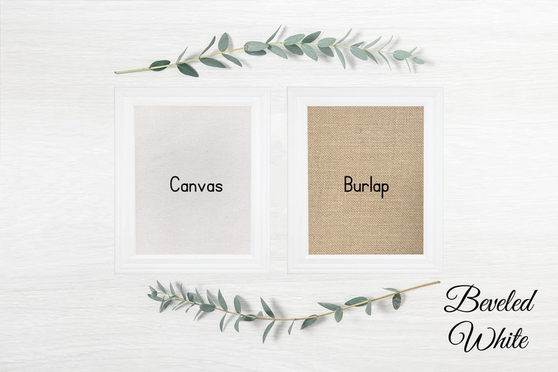 May include: Two white frames with beveled edges, one with a white canvas insert and the other with a burlap insert. The text "Canvas" is printed on the canvas insert and the text "Burlap" is printed on the burlap insert. The text "Beveled White" is printed below the frames.