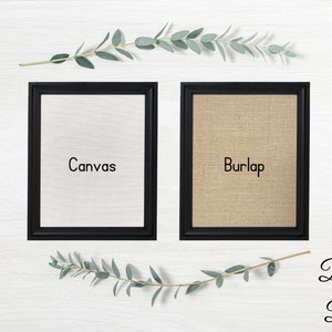 May include: Two black framed canvases, one with a white canvas insert labeled "Canvas" and the other with a burlap insert labeled "Burlap". The frames are beveled and black.