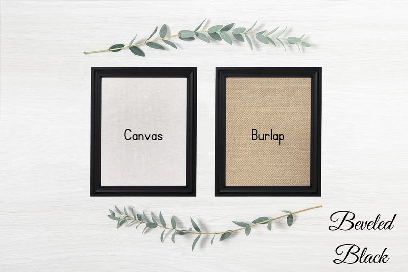 May include: Two black framed canvases, one with a white canvas insert labeled "Canvas" and the other with a burlap insert labeled "Burlap". The frames are beveled and black.