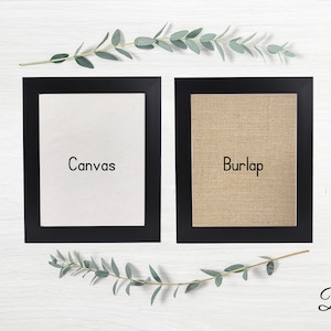 May include: Two framed canvases, one white canvas and one burlap canvas, both with black frames. The text "Canvas" is printed on the white canvas and the text "Burlap" is printed on the burlap canvas. The text "Black" is printed below the frames.