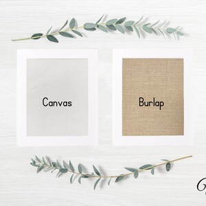 May include: Two framed samples of fabric, one white canvas and one brown burlap, with the words "Canvas" and "Burlap" printed below each sample. The background is a white wooden surface with a sprig of green eucalyptus leaves on either side of the samples.