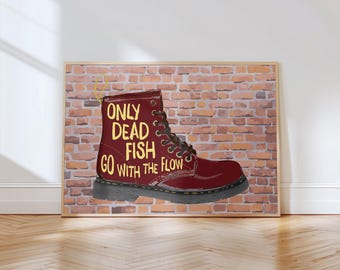 May include: Framed artwork showing a burgundy boot with the text "ONLY DEAD FISH GO WITH THE FLOW" in yellow. The boot is set against a brick wall background, with a wooden frame.