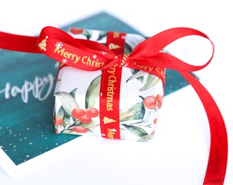 Christmas holiday greeting card with personalized note with the gift wrapped jewelry box