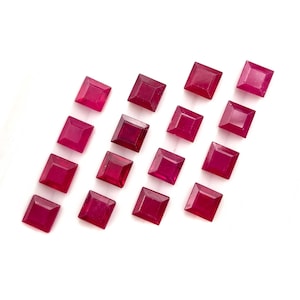 May include: Sixteen square-cut, deep red gemstones arranged in a four-by-four grid. Each stone features a faceted surface with a pointed centre, displaying a consistent vibrant crimson hue and a polished finish across all individual pieces.