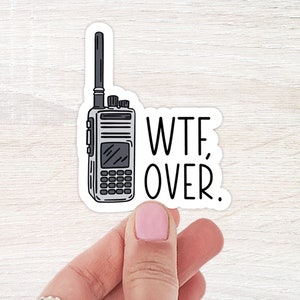 May include: A white sticker with a black and white illustration of a walkie talkie and the text "WTF, OVER."