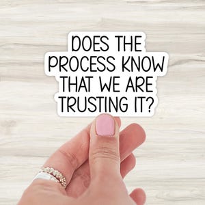 May include: White sticker with black text that reads "Does the process know that we are trusting it?"