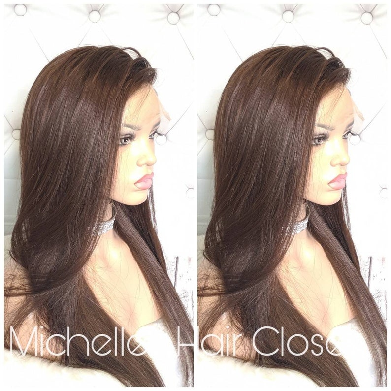 May include: A long, straight, brown human hair wig with a lace front. The wig is styled with a side part and falls to the shoulders.