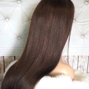 May include: A long, straight, dark brown human hair wig. The wig is styled with a center part and falls to the shoulders.